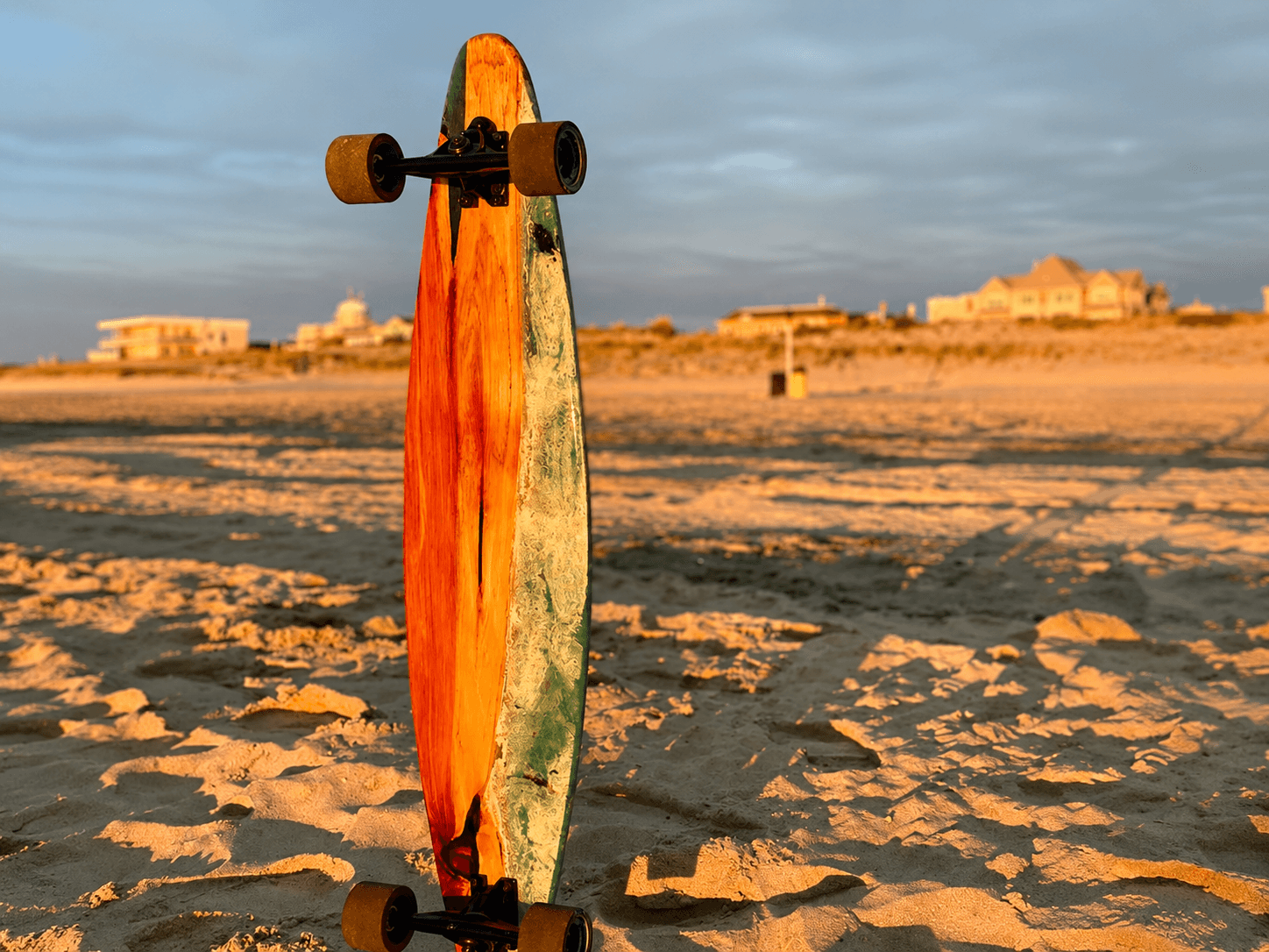 Cedar Ocean longboard on beach at golden hour